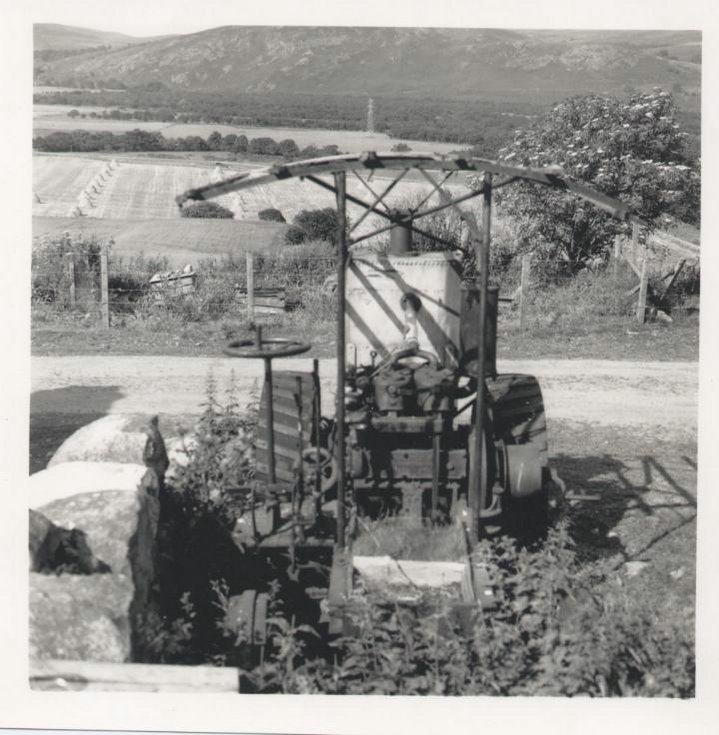 Torboll Street Farm tractor with sttoks in background