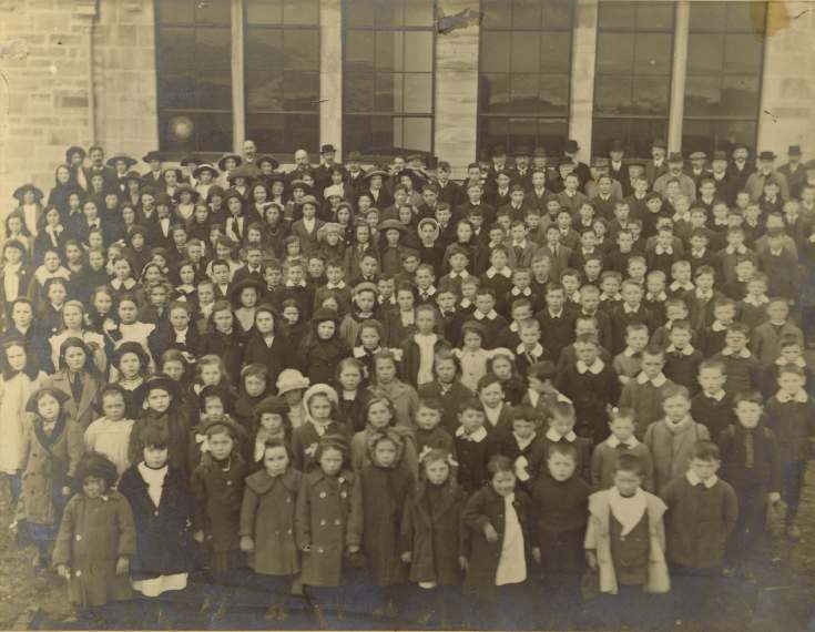 Photograph of the pupils and staff of Dornoch Academy at opening ceremony by Lord Kennedy, 1913.
