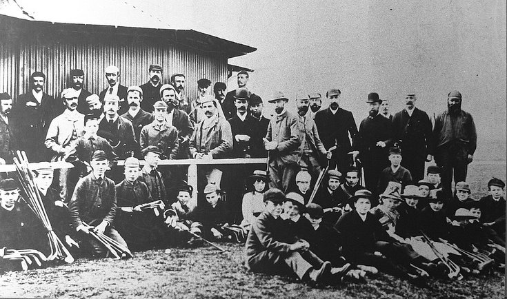 Group of caddies and golfers c 1905