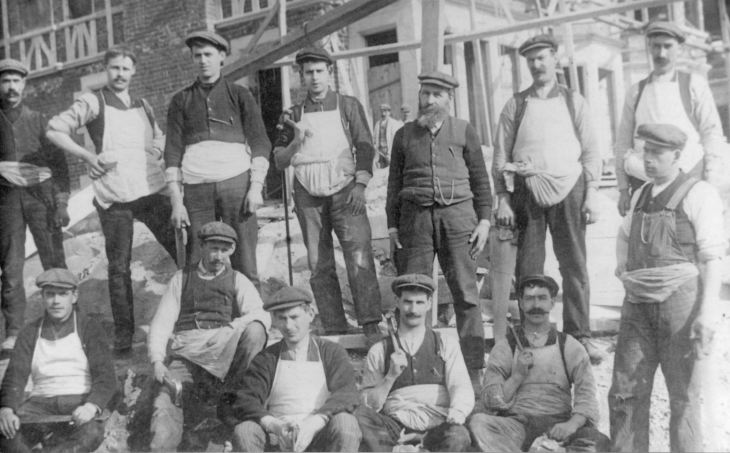 Tradesmen in front of building being refurbished