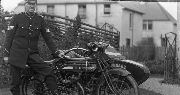 Police Sergeant standing with motorcyle with sidec