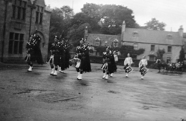Dornoch Pipe Band entering High Street