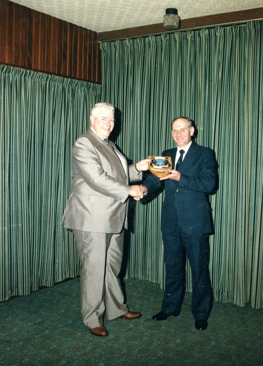 John Jappy receiving shield presented on retiremen