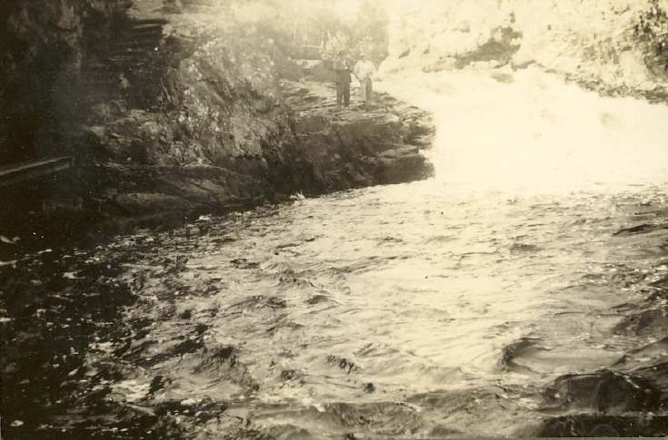 Two men standing on river bank