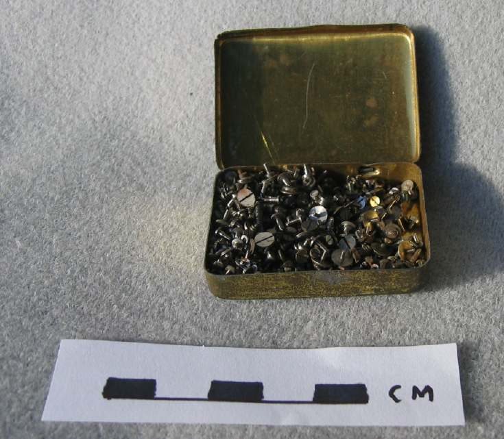 Small tin of watchmaker's screws