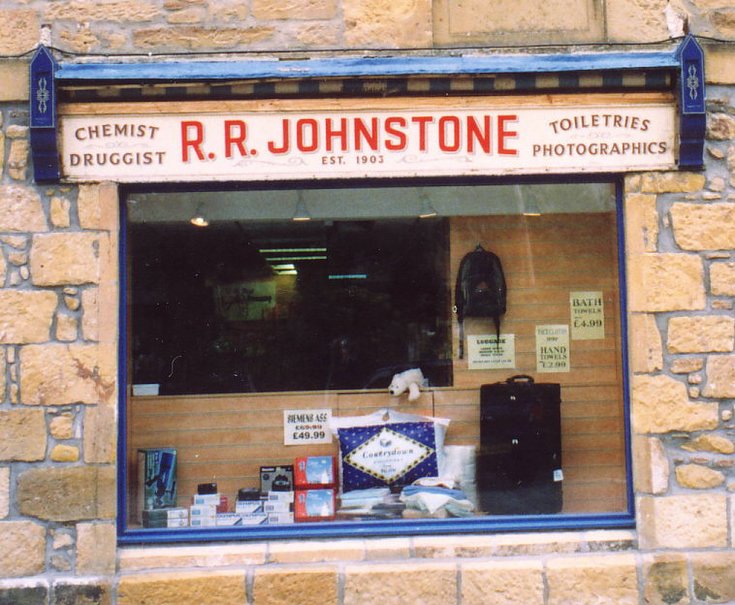 Close up of pre 2002 R R Johnstone Chemist Shop sign, Dornoch
