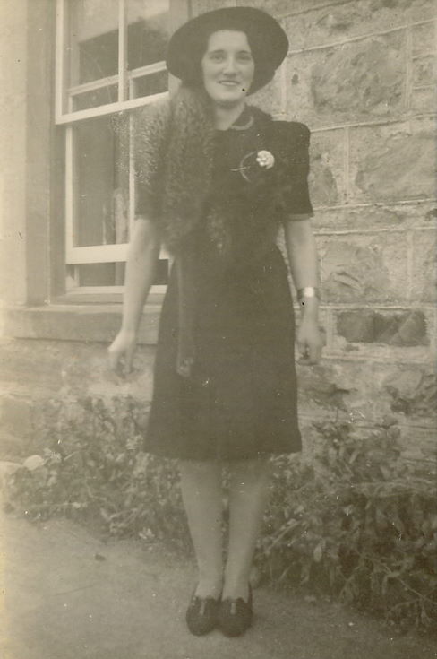 Woman standing outside a house ~ possibly