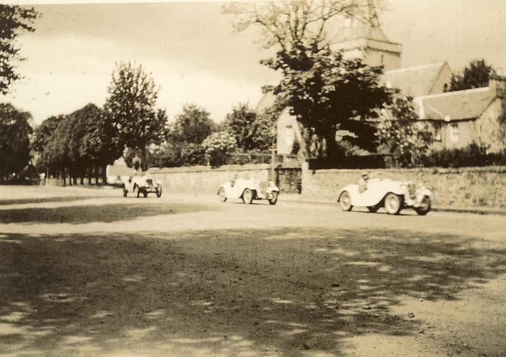 Three Sports Cars being driven along Castle Street, Dornoch