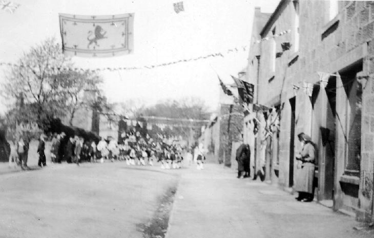 Pipe Band marching along Castle Street, Dornoch