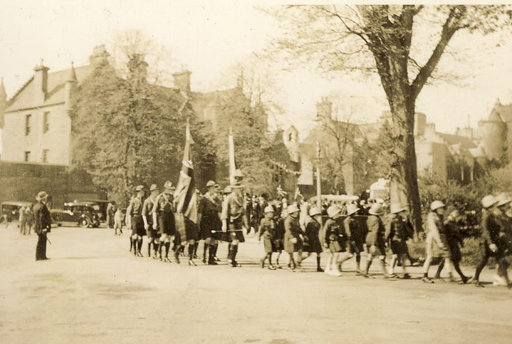 Girl Guides and Boy Scouts parading in Dornoch Square