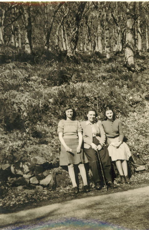 Group of lady and two girls sitting beside road