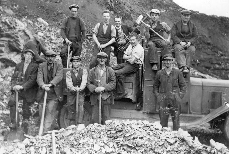 Group of workers gathered around their lorry