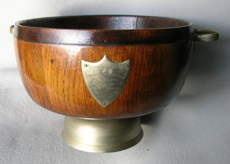 Wooden bowl with inscribed shield.