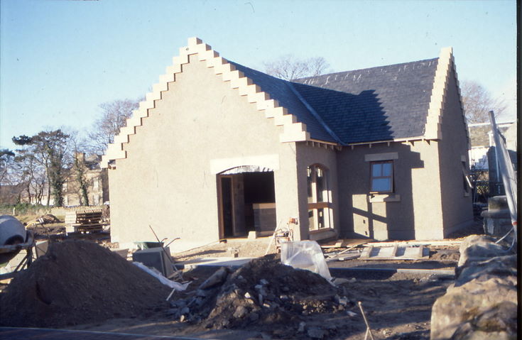 Western side with entrance door nearing completion
