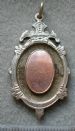 Oval mount medal, silver with gold central oval