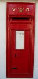 Royal Mail wall mounted postbox with VR insignia